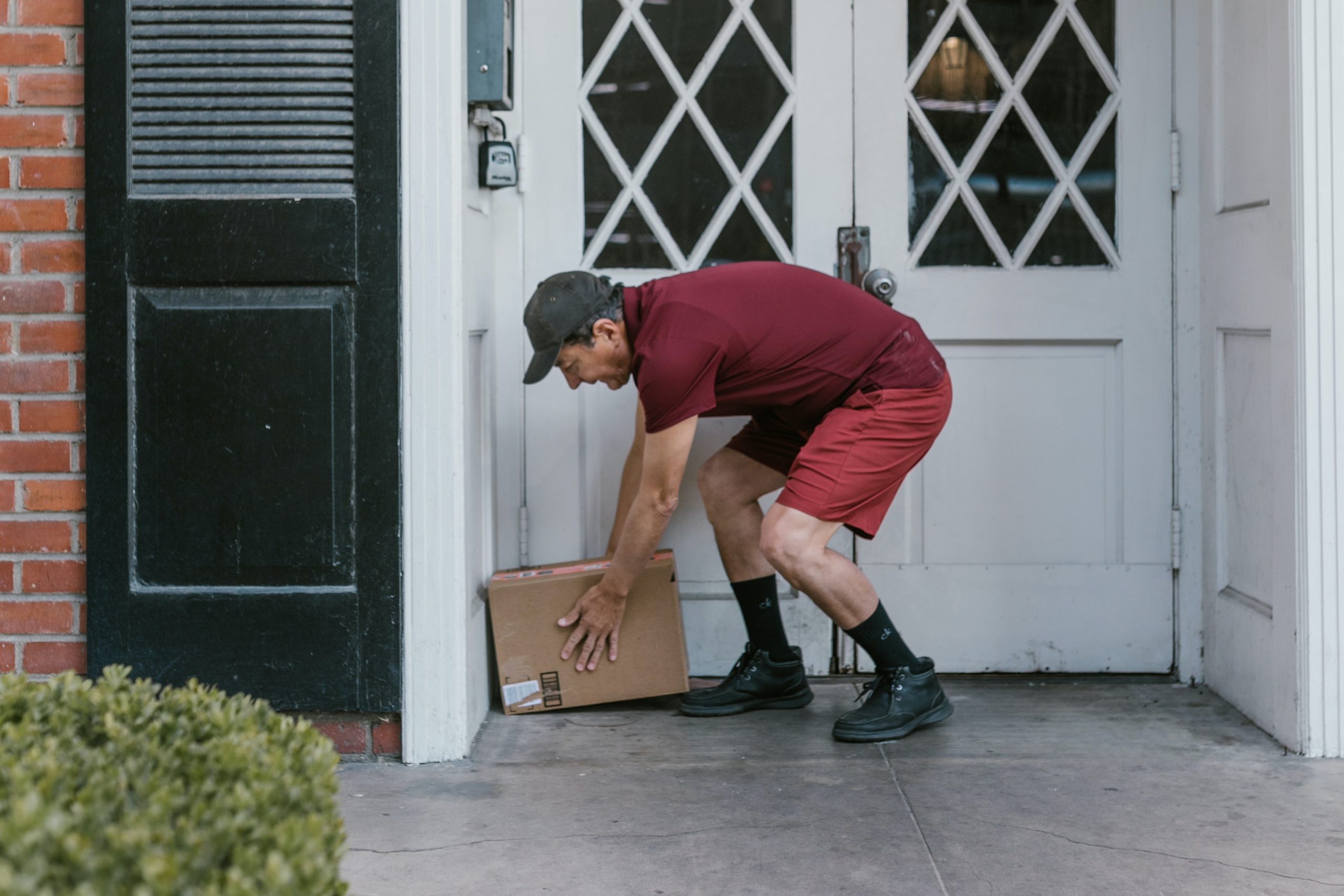 thief stealing a package from the front door